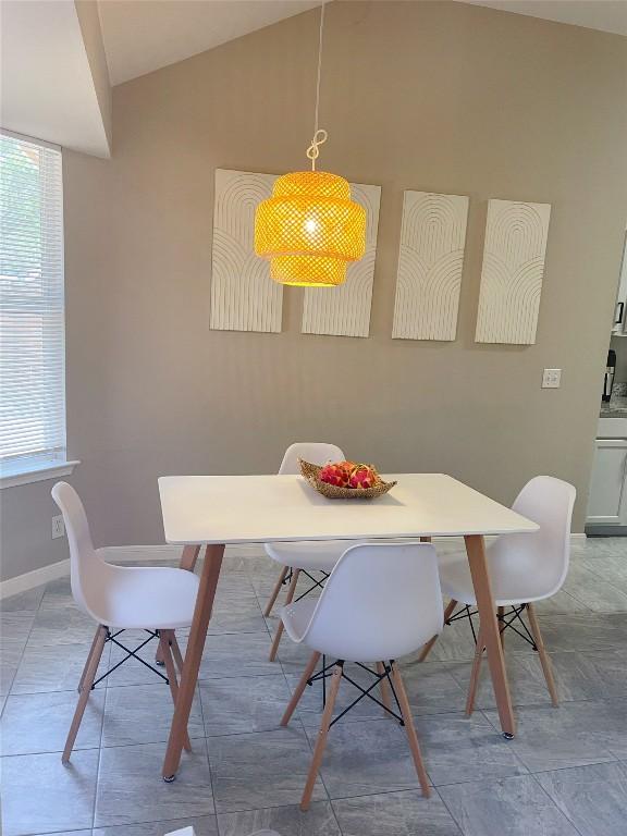 dining space with vaulted ceiling