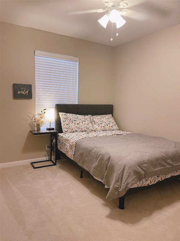 bedroom featuring ceiling fan and carpet floors