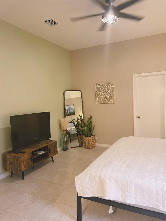 bedroom featuring light tile patterned floors and ceiling fan