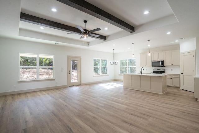 kitchen featuring sink, white cabinets, a kitchen island with sink, light hardwood / wood-style floors, and stainless steel appliances