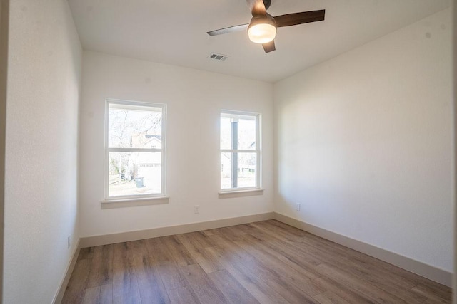 spare room featuring ceiling fan and light hardwood / wood-style floors