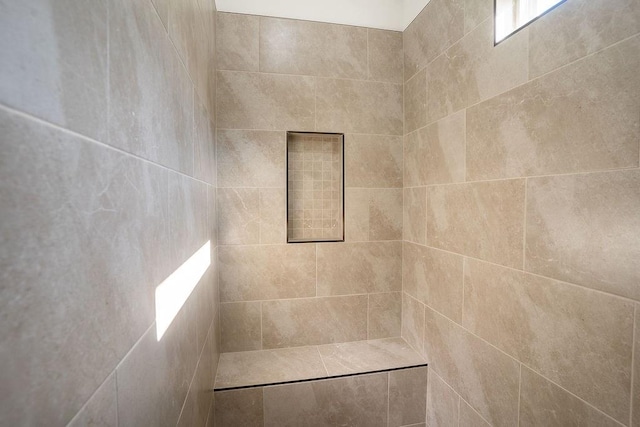 bathroom with a tile shower