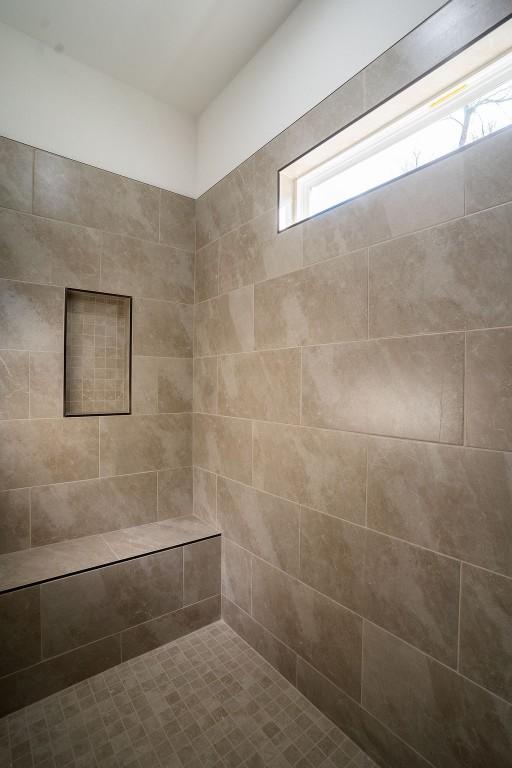 bathroom with a tile shower