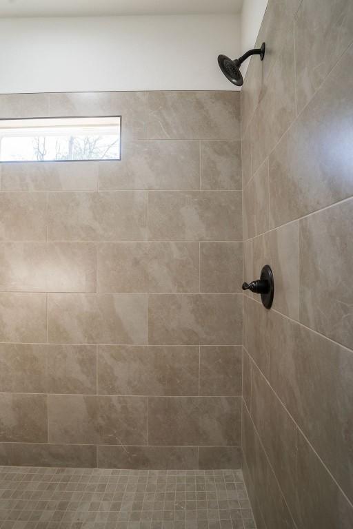 bathroom with tiled shower