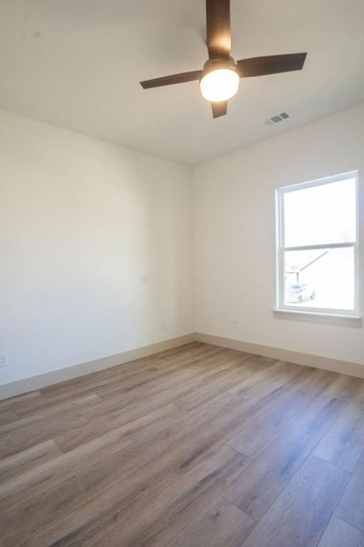 unfurnished room with ceiling fan and light hardwood / wood-style flooring