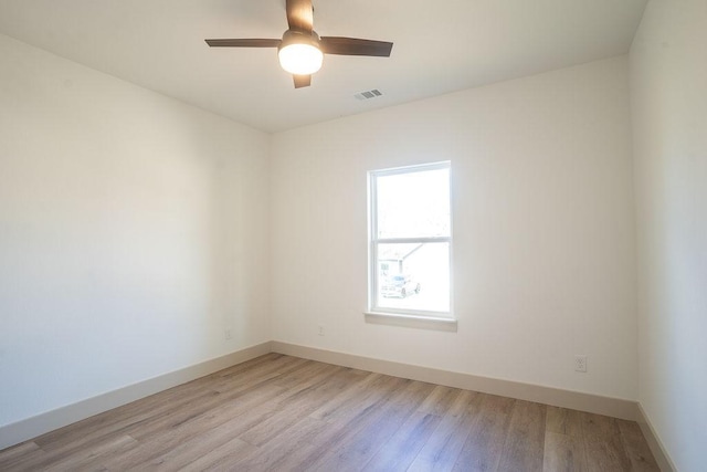 spare room with light hardwood / wood-style flooring and ceiling fan