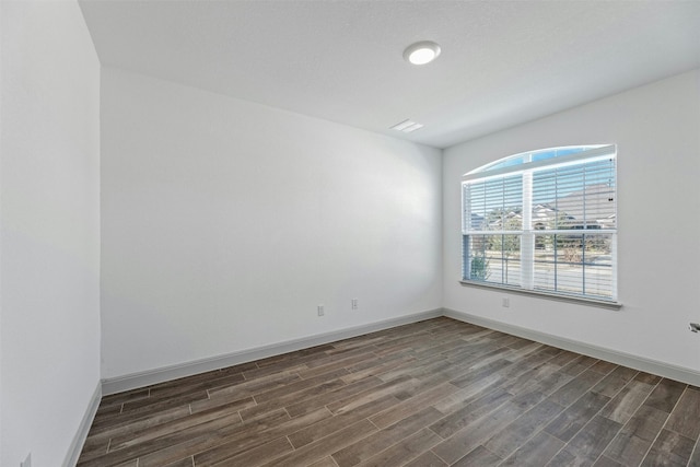 unfurnished room featuring dark hardwood / wood-style flooring