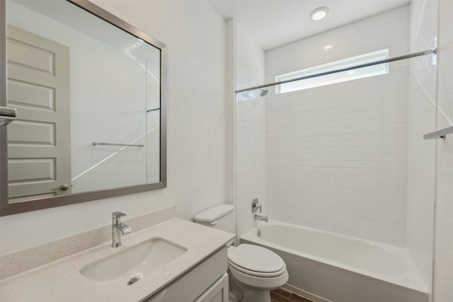 full bathroom with vanity, tiled shower / bath combo, and toilet