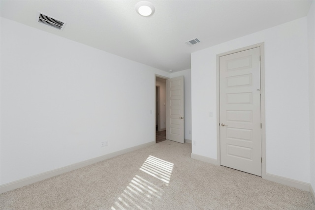 unfurnished bedroom with light colored carpet