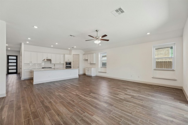 unfurnished living room featuring ceiling fan, wood-type flooring, and sink