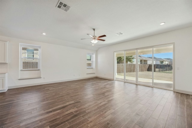 unfurnished living room featuring dark hardwood / wood-style floors and ceiling fan