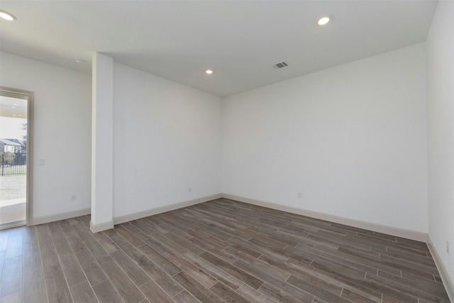 unfurnished room with dark hardwood / wood-style floors