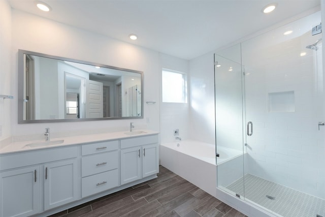 bathroom with shower with separate bathtub and vanity