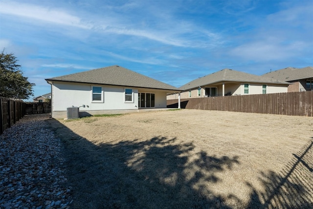 rear view of house featuring central AC