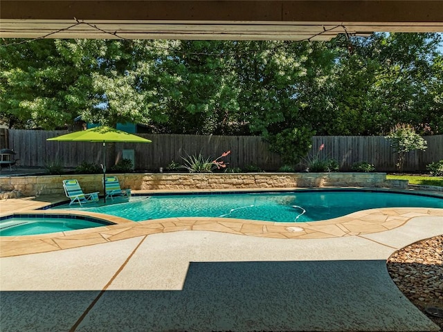 view of pool featuring an in ground hot tub and a patio