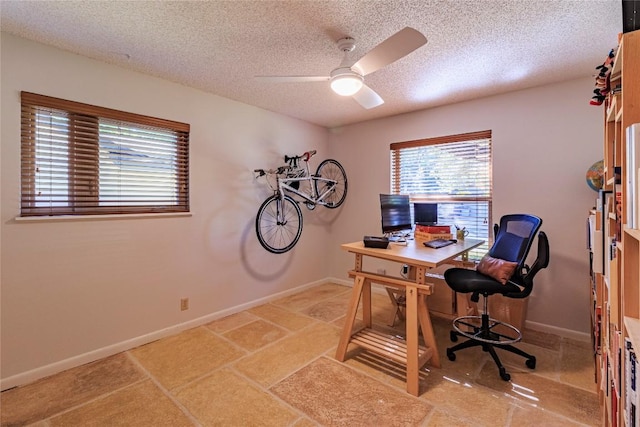 home office with ceiling fan and a textured ceiling