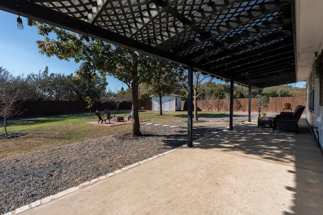 view of patio with an outdoor living space and a shed