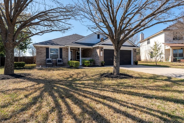 view of front of property with a porch, a garage, and a front yard