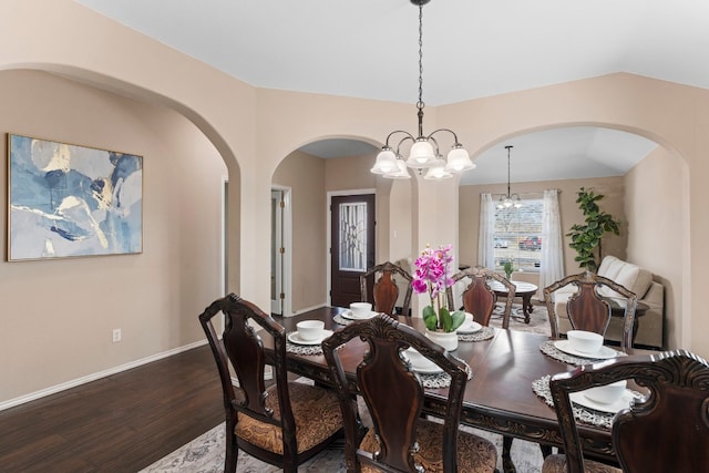 dining room featuring lofted ceiling and hardwood / wood-style floors