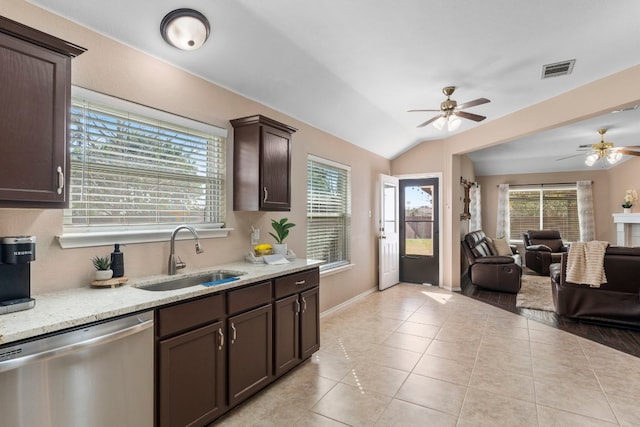 kitchen featuring light tile patterned flooring, dishwasher, lofted ceiling, sink, and dark brown cabinets