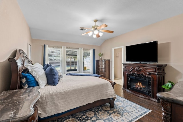 bedroom featuring vaulted ceiling, dark wood-type flooring, and ceiling fan