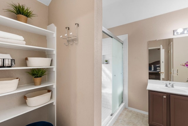 bathroom with a shower with door and vanity