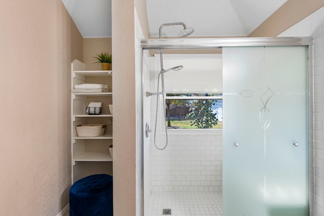 bathroom featuring a shower with door