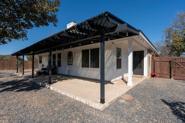 rear view of property featuring a patio area