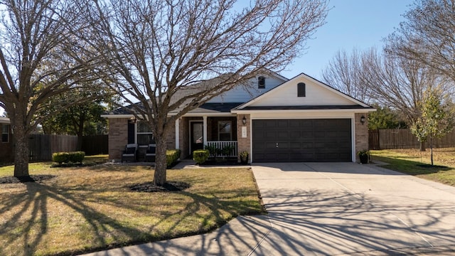 single story home featuring a garage, a front yard, and a porch