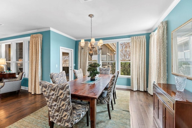 dining space featuring crown molding, dark hardwood / wood-style floors, and a chandelier