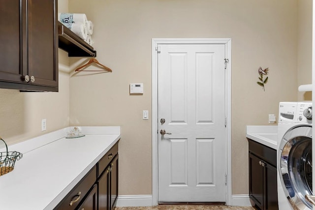 laundry area with washer / clothes dryer and cabinets