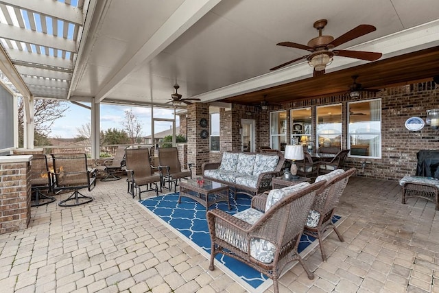 view of patio / terrace with ceiling fan and an outdoor living space