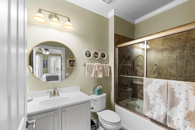 full bathroom featuring shower / bath combination with glass door, ceiling fan, vanity, ornamental molding, and toilet