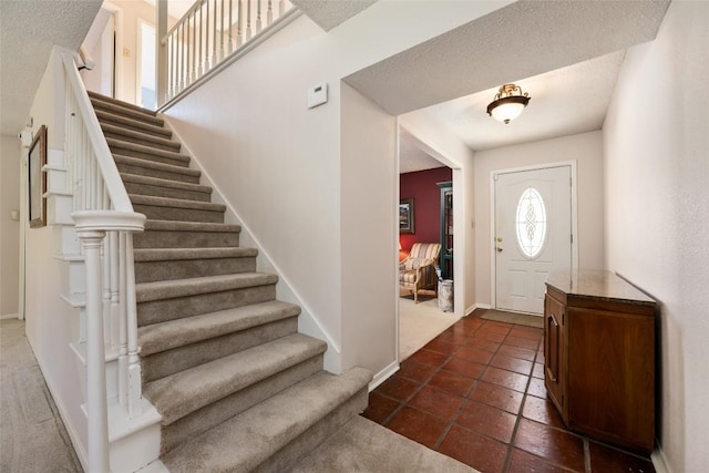 foyer entrance featuring a textured ceiling