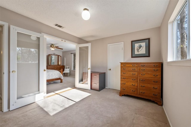 unfurnished bedroom with light carpet and a textured ceiling