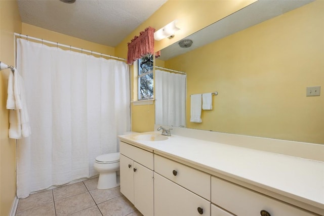 bathroom featuring tile patterned flooring, vanity, a textured ceiling, and toilet