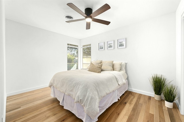1801 Duke Ave, Austin, TX 78757 - bedroom with baseboards, light wood finished floors, and ceiling fan