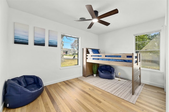 1801 Duke Ave, Austin, TX 78757 - bedroom with hardwood / wood-style floors, multiple windows, baseboards, and a ceiling fan