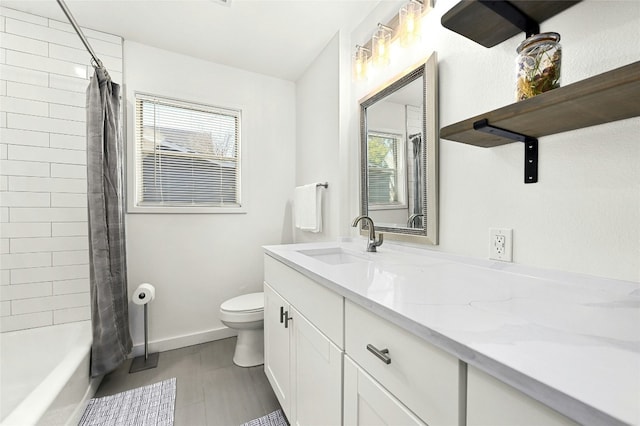 1801 Duke Ave, Austin, TX 78757 - full bathroom with toilet, plenty of natural light, vanity, and baseboards