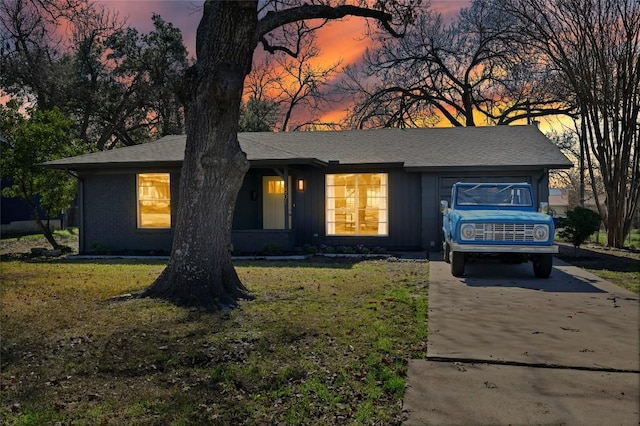 view of front of home with a yard and a garage