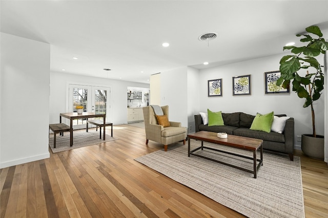 1801 Duke Ave, Austin, TX 78757 - living room featuring french doors, light wood-style flooring, recessed lighting, and baseboards