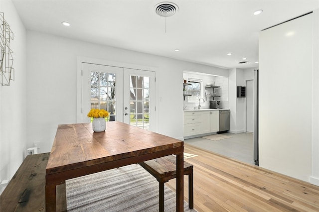 1801 Duke Ave, Austin, TX 78757 - dining area featuring light wood finished floors, french doors, and recessed lighting
