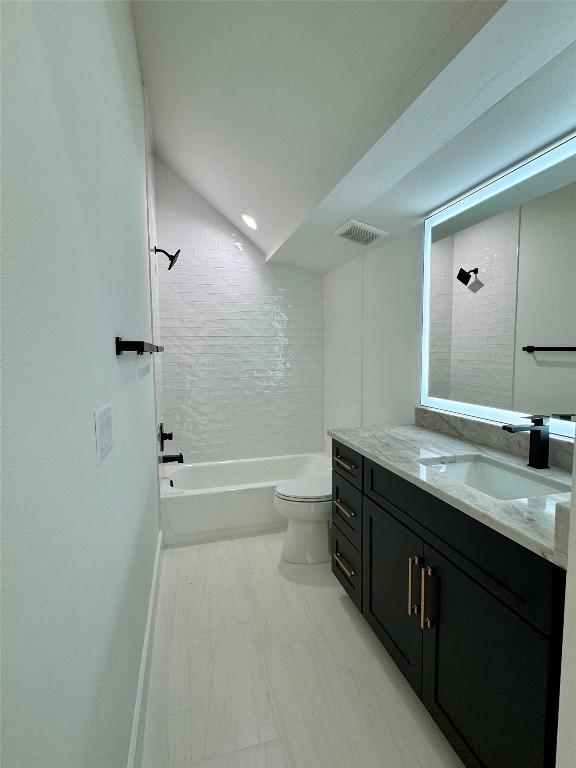 1708 Canterbury St Unit 1, Austin, TX 78702 - bathroom featuring vanity, toilet, shower / washtub combination, and baseboards