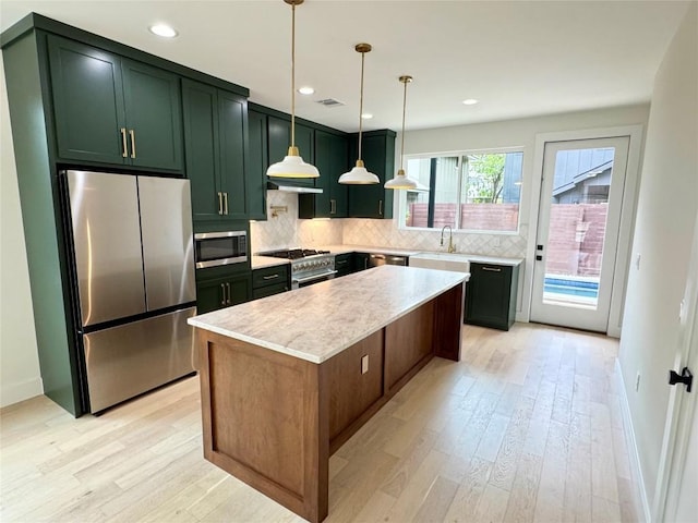 1708 Canterbury St Unit 1, Austin, TX 78702 - kitchen with appliances with stainless steel finishes, light wood-style floors, tasteful backsplash, light countertops, and recessed lighting