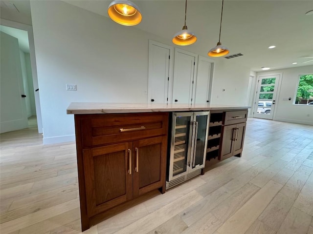 1708 Canterbury St Unit 1, Austin, TX 78702 - bar area featuring wine cooler, light wood finished floors, hanging light fixtures, baseboards, and recessed lighting