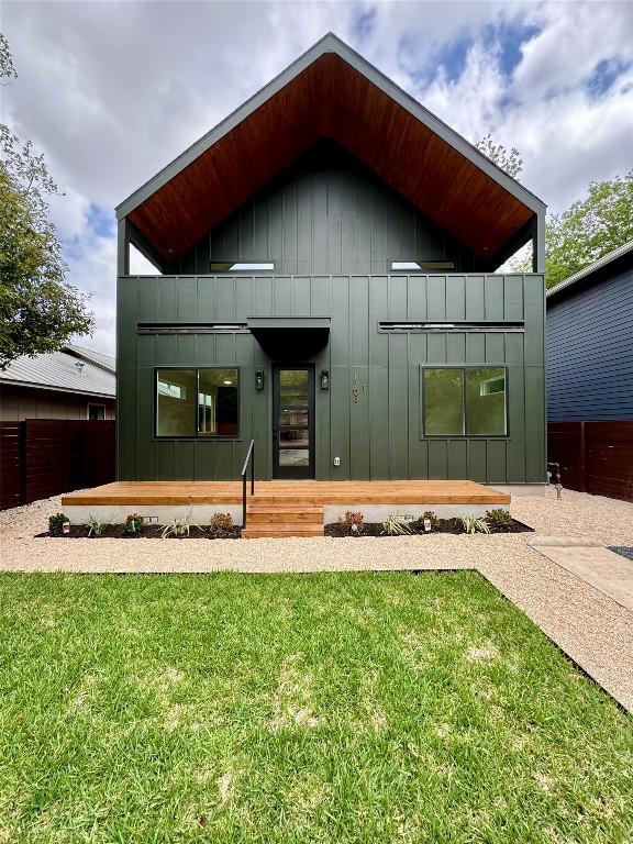 1708 Canterbury St Unit 1, Austin, TX 78702 - view of front of home featuring a balcony, board and batten siding, a front yard, and covered porch