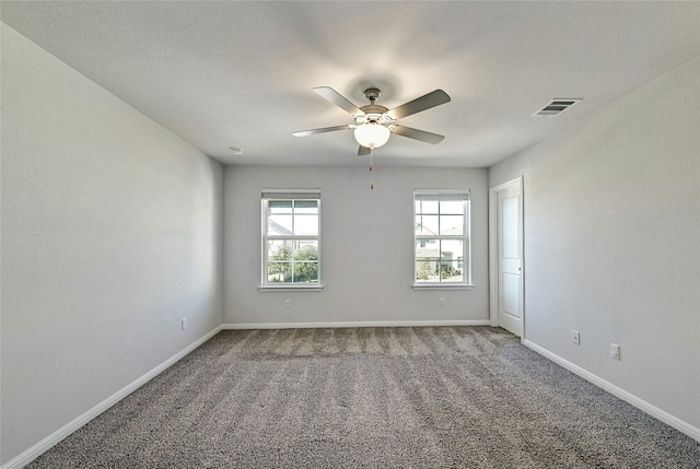 carpeted empty room featuring ceiling fan