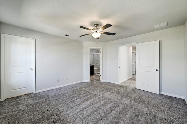 unfurnished bedroom with connected bathroom, carpet floors, and ceiling fan