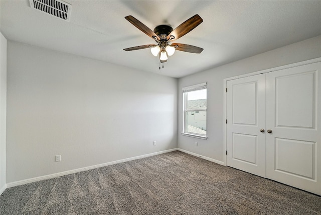 unfurnished bedroom featuring a closet, ceiling fan, and carpet flooring