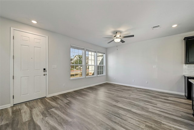 unfurnished living room featuring ceiling fan and wood-type flooring